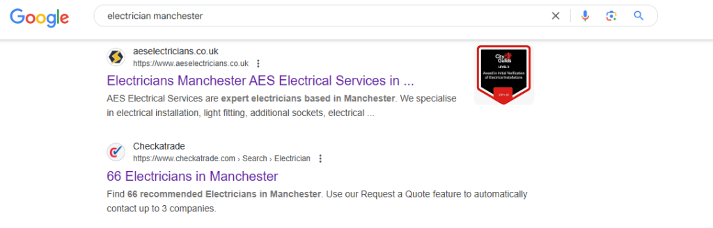 Google results for the search electrician manchester with an electrician's own website listed above the Checkatrade directory page