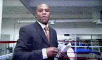 Man in a suit beside a boxing ring counting a wad of cash, a meme for throwing money at Facebook ads